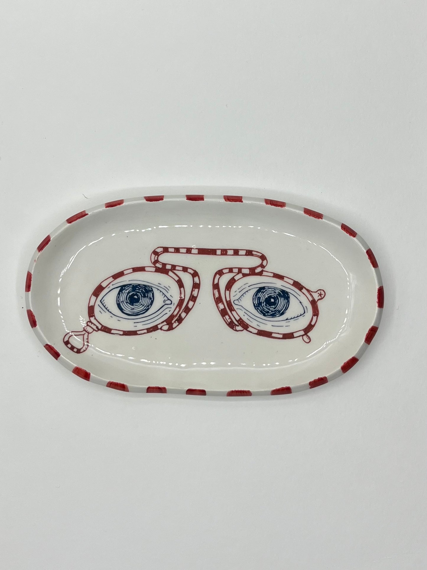 Piattino ovale in ceramica con disegno 4 occhi