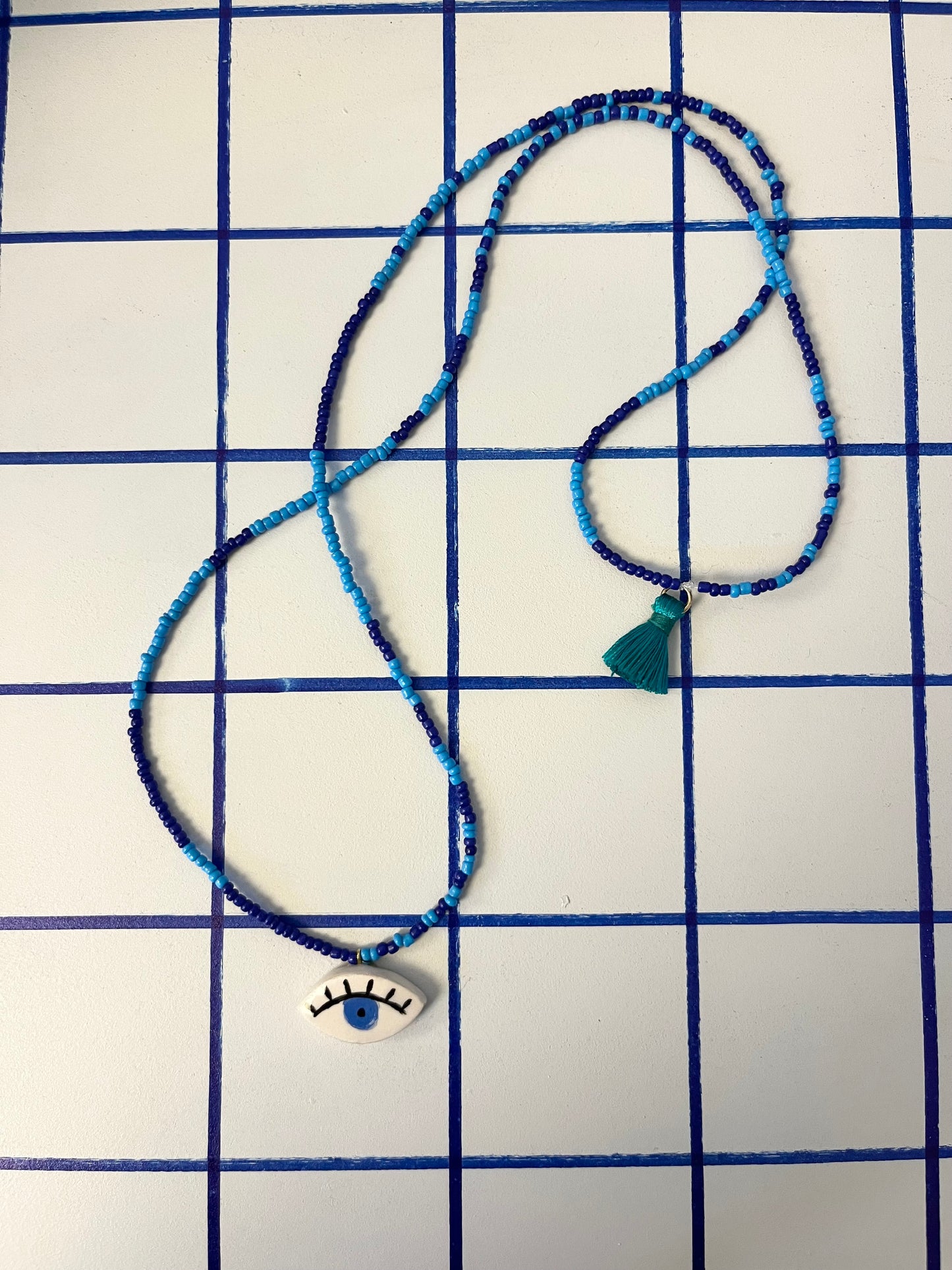 collana talisMANO con ciondolo a forma di occhio  e perline colorate